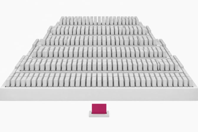 A single accented hardware token sits in front of a sharply stepped structure holding hundreds of identical blank tokens in a dense grid, illustrating the escalating volume of per-seat SaaS billing.