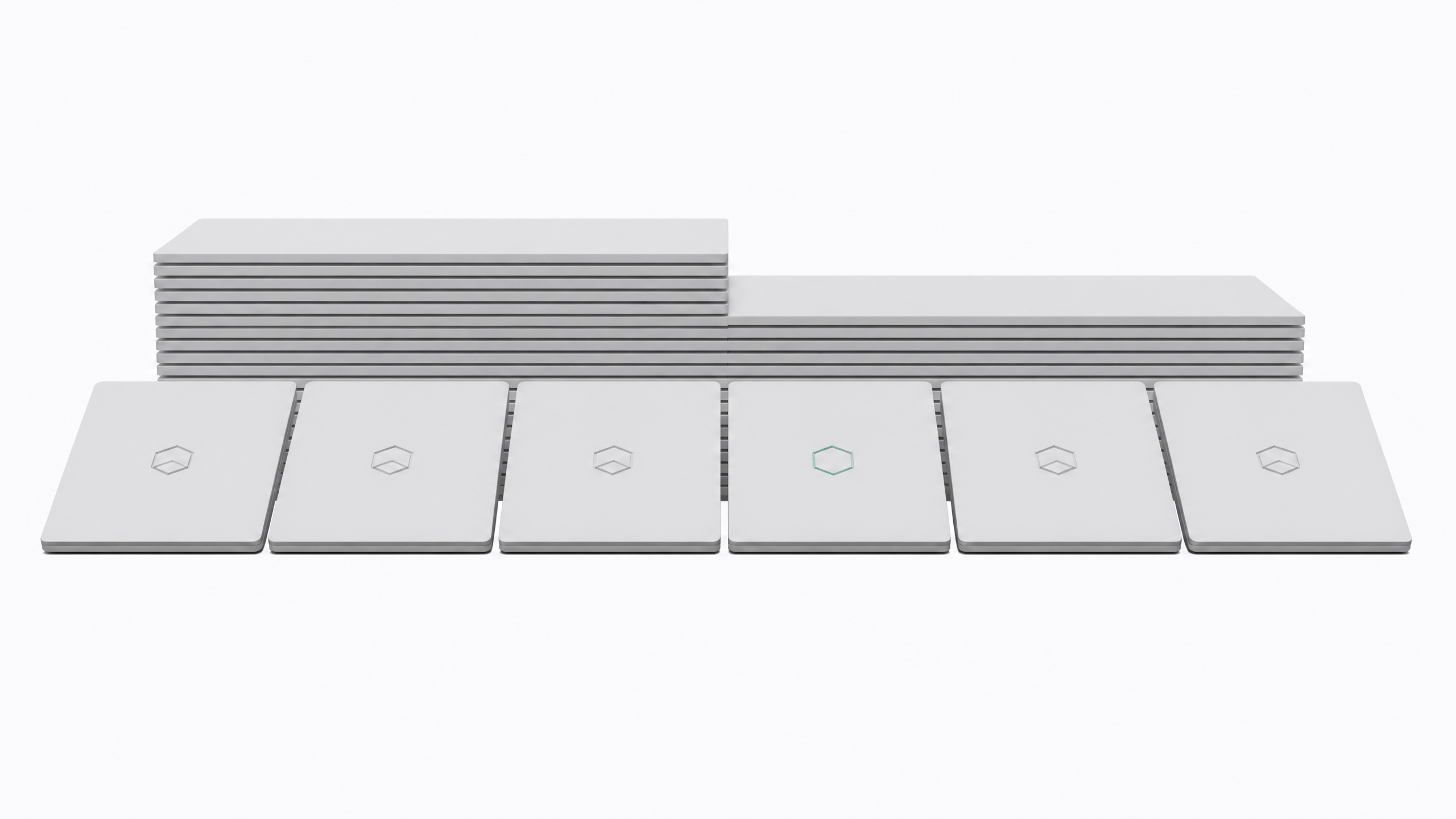 A line of nearly identical laptops with a chip-badge logo, where one laptop in the middle is missing its badge, illustrating Microsoft quietly dropping its Copilot+ PC branding.